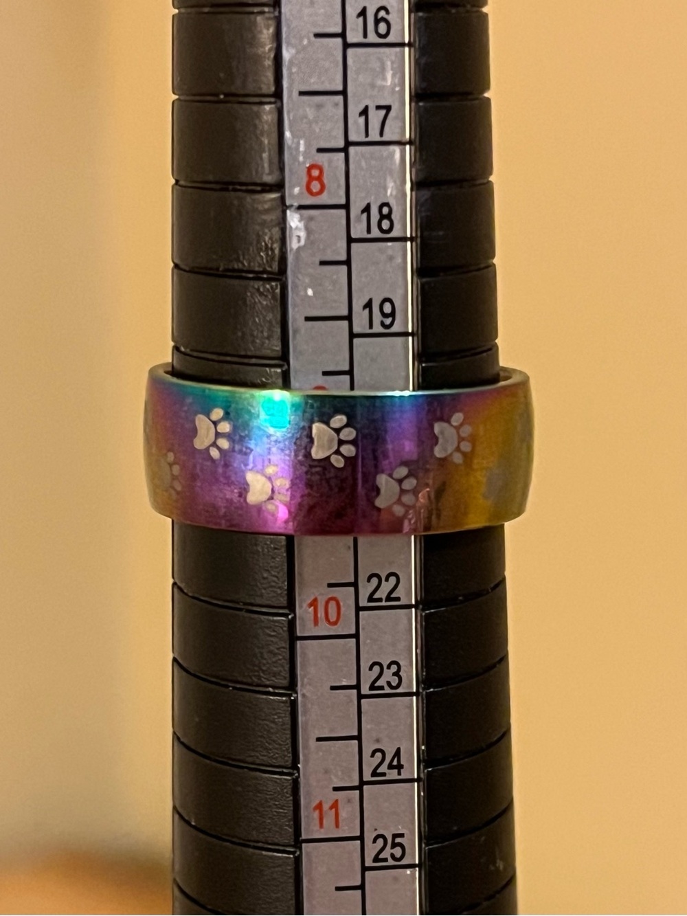 Rainbow ring with paw prints all around with a silver tone band size 9